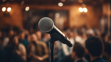 Microphone Stands Sharp Against A Blurred Backdrop Of A Conference Hall Filled With Attendees
