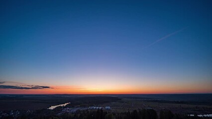 Wall Mural - Sunset timelapse above the valley, view from the mountain. Blue sky with moving clouds. Beautiful landscape, 4k