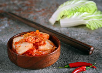 Poster - fermented Korean cabbage kimchi in a wooden bowl