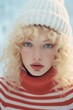 © Glittering Humanity - A stunningly beautiful woman with golden locks dons a cozy red and white striped sweater and a white beanie, exuding the perfect balance of fashion and winter vibes in this striking outdoor portrait