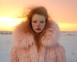 © Glittering Humanity - A stunning fashionista braves the wintry winds, her pink coat a vibrant contrast against the snowy backdrop as she stands confidently in a field, her fur-lined collar protecting her from the elements