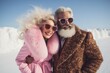 © Glittering Humanity - An eccentric older couple braves the winter chill with funky fashion, donning sunglasses and fur as they strike a pose against the snowy sky
