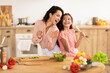 © Prostock-studio - Mommy and daughter singing in kitchen enjoying cooking fun