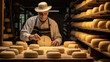Cheesemaker is controlling the seasoning lots of wheels of parmesan cheese are maturing by ancient Italian tradition for many months on shelves of a storehouse in a cheese factory.