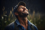 Fototapeta  - A happy farmer in a sown field getting soaked in the rain looking at the sky grateful and excited because it is raining. Drought, climate, weather and environmental issues concept