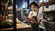 © MP Studio - Young girl in the kitchen looking at her phone checking a recipe for cooking