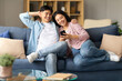 © Prostock-studio - Happy Japanese spouses browsing internet at cozy home