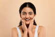 © Prostock-studio - Skincare Concept. Beautiful young indian woman touching face and looking at camera