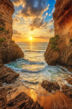 A Beautiful Sunset Over The Ocean With A Rocky Cliff Face And A Beach Below It With Waves Crashing In