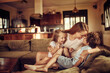 © Geber86 - Young mother bonding with her children on the couch in the living room at home