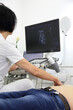 Ultrasonic examination of internal organs. A man on an abdominal ultrasound scan. Apparatus for ultrasonic examination. Modern ultrasound machine. 