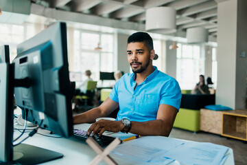 Young African American man working on the computer in a office