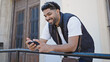 © Krakenimages.com - African american man smiling confident using smartphone at street