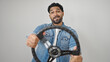© Krakenimages.com - African american man smiling confident using steering wheel as a driver over isolated white background
