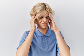 Poster - Young modern man standing over isolated background with hand on head for pain in head because stress. suffering migraine.