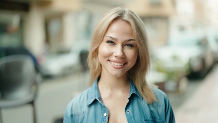 Poster - Young blonde woman smiling confident standing at street