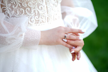 Wall Mural - The bride adjusts the wedding ring on her finger. Wedding ceremony.