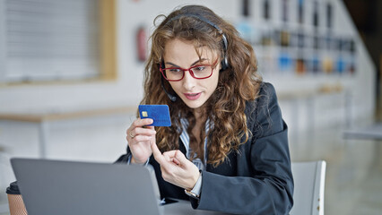 Poster - Young woman business worker having video call holding credit card at the office