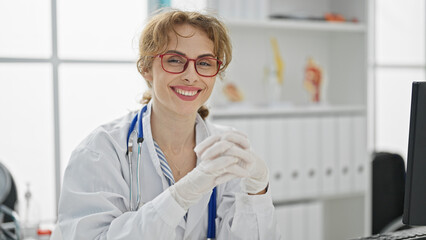 Poster - Young woman doctor wearing gloves smiling at the clinic