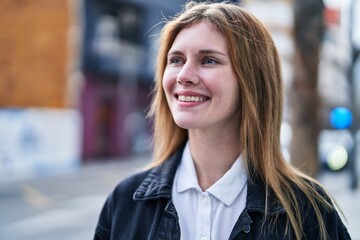 Poster - Young blonde woman smiling confident looking to the side at street