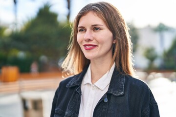 Poster - Young blonde woman smiling confident looking to the side at park