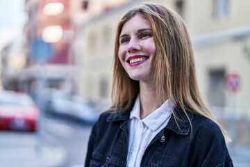 Canvas Print - Young blonde woman smiling confident looking to the side at street