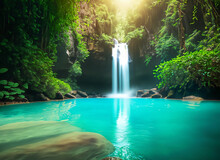 A Hidden Waterfall In The Heart Of The Tropical Jungle, Crystal-clear Water Falling Into An Emerald Pool