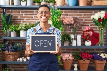 Sticker - African american woman working at florist holding open sign smiling with a happy and cool smile on face. showing teeth.