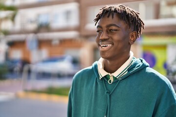 Wall Mural - African american man smiling confident looking to the side at street