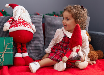 Poster - Adorable hispanic toddler smiling confident sitting on sofa with christmas decoration at home