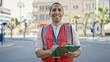 © Krakenimages.com - Young hispanic man volunteer smiling holding clipboard at street