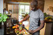 © Marko Geber - Middle aged fit man making a healthy smoothie in the kitchen at home