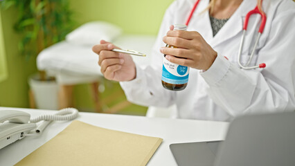 Wall Mural - Young blonde woman doctor prescribing medication treatment at clinic