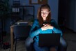 © Krakenimages.com - Brunette woman working at the office at night smiling with hands on chest with closed eyes and grateful gesture on face. health concept.
