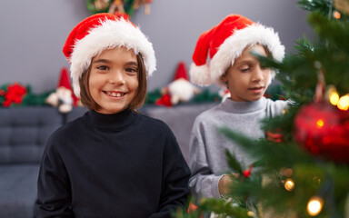 Poster - Adorable boys smiling confident decorating christmas tree at home