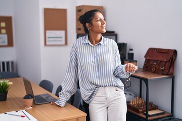 Canvas Print - Young beautiful hispanic woman business worker smiling confident holding glasses at office