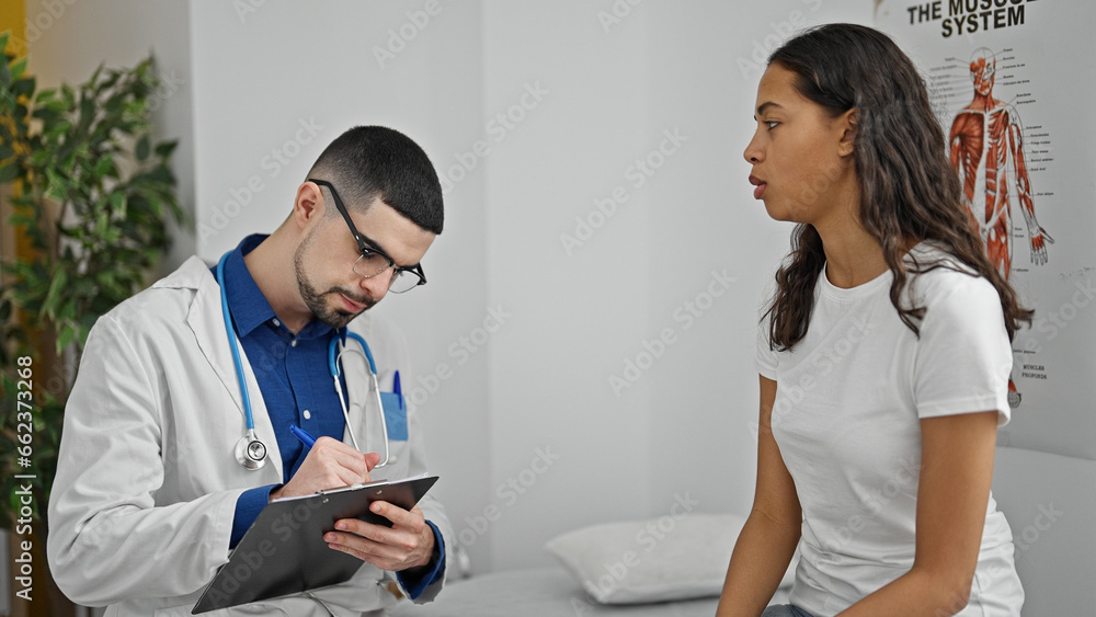 Serious healthcare worker concentrates on writing patient's medical ...