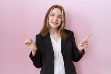 Poster - Young caucasian business woman wearing black jacket smiling confident pointing with fingers to different directions. copy space for advertisement