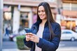 © Krakenimages.com - Young beautiful hispanic woman smiling confident using smartphone at street