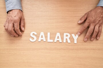 Sticker - Middle age grey-haired man business worker sitting on table with salary word at office