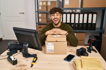 Canvas Print - Arab man with beard working at small business ecommerce smiling and laughing hard out loud because funny crazy joke.