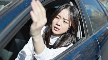 Sticker - Young chinese woman stressed driving car at street