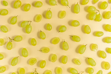 Wall Mural - White grapes on yellow background. Fruit background.