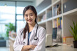 © Canvas Alchemy - Young Chinese woman wearing doctor uniform and stethoscope with a happy smile. Lucky person