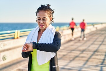 Sticker - Middle age hispanic woman working out with smart watch at promenade