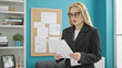 © Krakenimages.com - Young blonde woman business worker reading document at the office