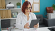 © Krakenimages.com - Middle age woman business worker using touchpad with serious face at the office