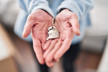 Sticker - Young hispanic man holding key at new home