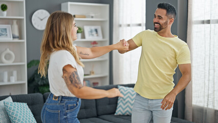 Canvas Print - Man and woman couple dancing together at home