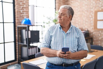 Poster - Middle age grey-haired man business worker smiling confident using smartphone at office